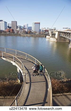 three teenage girls on a pedestrian bridge over a river View Large Photo Image Stock Photo - three teenage girls on a pedestrian bridge over a river. Fotosearch
