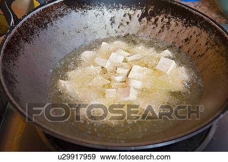 Stock Photo - tofu frying in the wok. Fotosearch