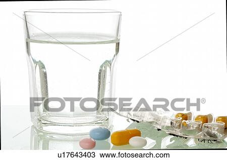 A glass of water and some pills View Large Photo Image Stock Image - A glass of water and some pills. Fotosearch