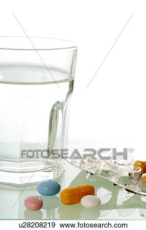 Stock Photo - A glass of water and some pills. Fotosearch