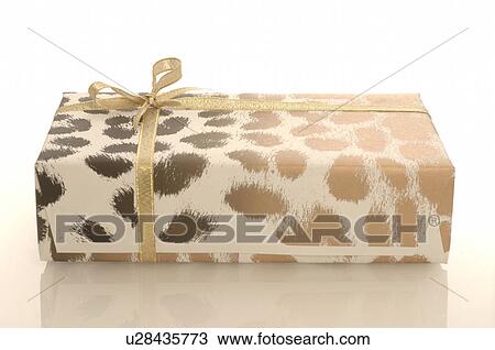 Stock Image - Animal print gift with a golden ribbon. Fotosearch