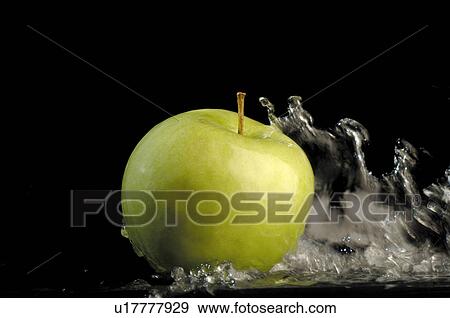 Apple in running water View Large Photo Image Stock Photo - Apple in running water. Fotosearch
