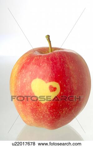 Stock Photo - Apple with a heart pattern. Fotosearch