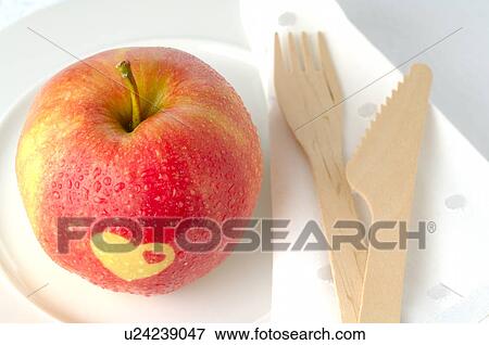 Stock Photo - Apple with a heart pattern. Fotosearch