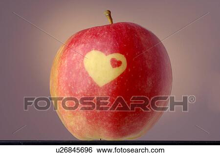 Stock Photograph - Apple with a heart pattern. Fotosearch