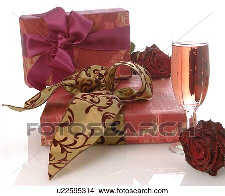 Picture - Arrangement of gifts, rose and glass of sparkling wine. Fotosearch