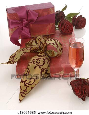 Stock Photography - Arrangement of gifts, rose and glass of sparkling wine. Fotosearch