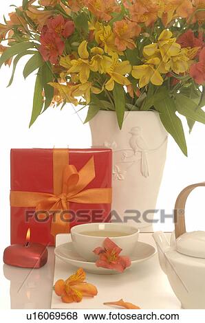 Arrangement of tea pot, a cup of tea, gift and bouquet View Large Photo Image Stock Photo - Arrangement of tea pot, a cup of tea, gift and bouquet. Fotosearch