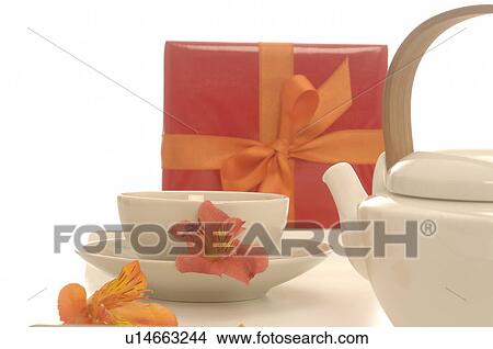 Picture - Arrangement with tea cup and tea pot and wrapped gift. Fotosearch