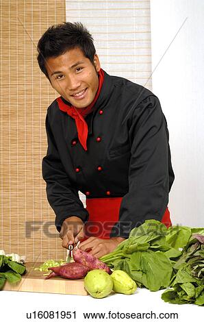 Stock Image - Asian chef preparing food. Fotosearch