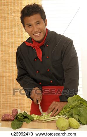 Stock Image - Asian chef preparing food. Fotosearch