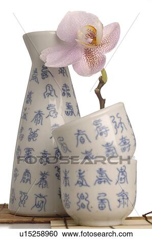 Asian crockey with blue characters and orchid blossom View Large Photo Image Stock Image - Asian crockey with blue characters and orchid blossom. Fotosearch