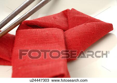 Stock Image - Asian place setting with a red napkin and chopsticks. Fotosearch