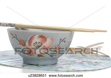 Stock Image - Asian tea cup with chopsticks. Fotosearch