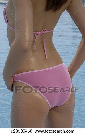 Back view of a woman in a pink bikini View Large Photo Image Stock Image - Back view of a woman in a pink bikini. Fotosearch