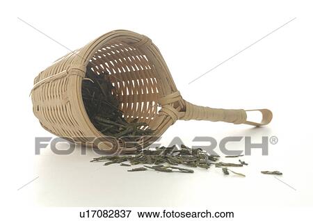 Stock Photo - Bamboo tea strainer and green tea. Fotosearch
