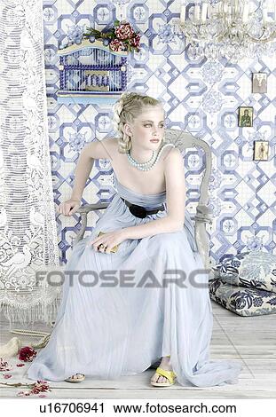 Stock Image - Blonde beauty in room of the 70th. Fotosearch