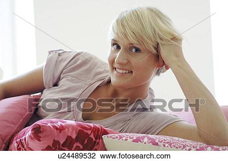 Blonde woman on sofa View Large Photo Image Stock Image - Blonde woman on sofa. Fotosearch