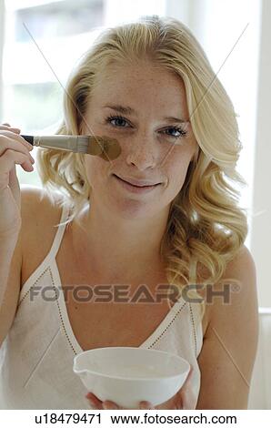 Blonde woman spreading on a healing earth mask View Large Photo Image Stock Image - Blonde woman spreading on a healing earth mask. Fotosearch