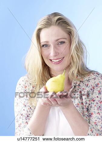 Blonde woman with pear View Large Photo Image Stock Image - Blonde woman with pear. Fotosearch