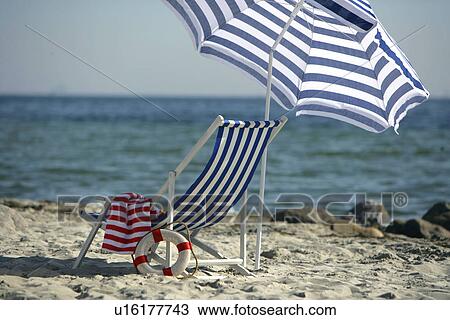 Blue and white sunshade and deckchair on the beach View Large Photo Image Stock Image - Blue and white sunshade and deckchair on the beach. Fotosearch