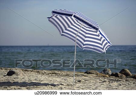Blue and white sunshade on the beach View Large Photo Image Stock Photo - Blue and white sunshade on the beach. Fotosearch