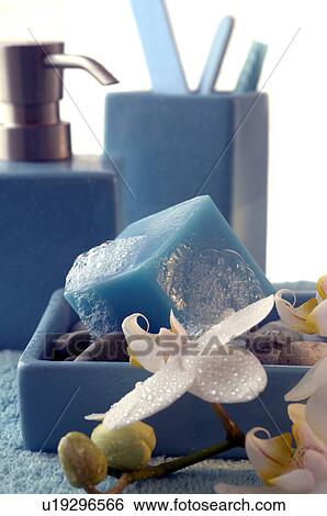 Stock Photograph - Blue soap cube and a orchid blossom. Fotosearch