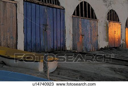 Stock Image - boathouse in the evening light. Fotosearch