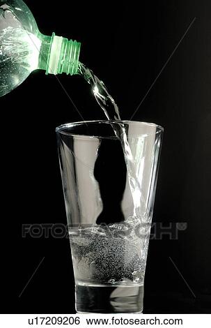 Bottled water being poured into glass View Large Photo Image Stock Photograph - Bottled water being poured into glass. Fotosearch
