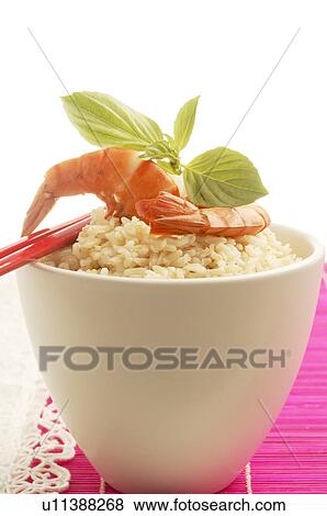 Stock Photo - Bowl filled with rice and prawns on top. Fotosearch