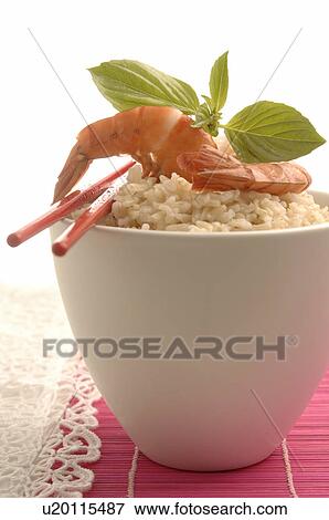 Stock Photo - Bowl filled with rice and prawns on top. Fotosearch