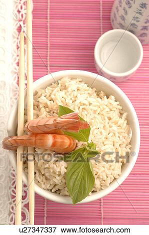 Stock Photo - Bowl filled with rice and prawns on top. Fotosearch