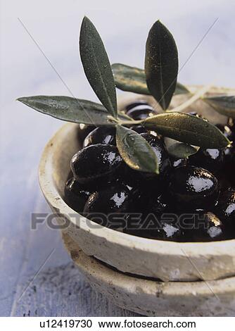Stock Image - Bowls with black olives (Olea europaea). Fotosearch