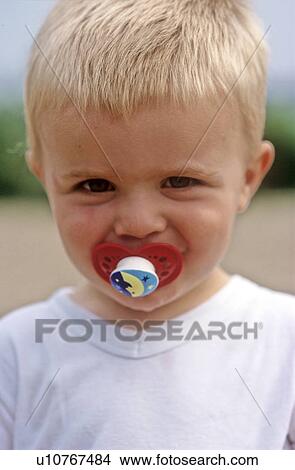 Picture - Boy toddler with dummy. Fotosearch