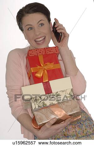 Brunette with mobile and presents View Large Photo Image Stock Photo - Brunette with mobile and presents. Fotosearch
