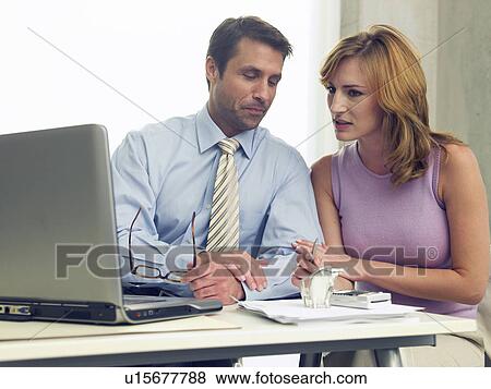 Stock Photo - Business couple at the computer. Fotosearch