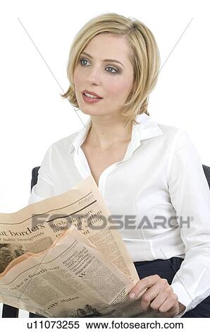 Stock Photography - Businesswoman reading newspaper. Fotosearch