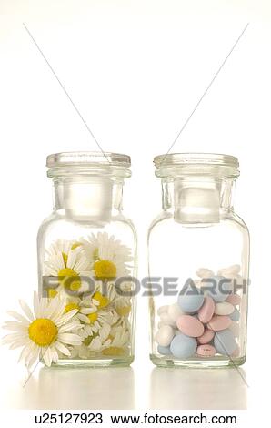 Camomile blossoms and pills in a bottle View Large Photo Image Stock Image - Camomile blossoms and pills in a bottle. Fotosearch