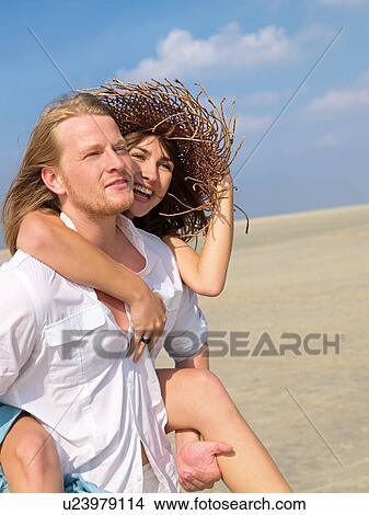 Cheery couple on the beach View Large Photo Image Picture - Cheery couple on the beach. Fotosearch