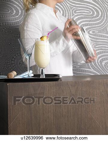 Stock Photograph - Cocktail bar and bar tender. Fotosearch