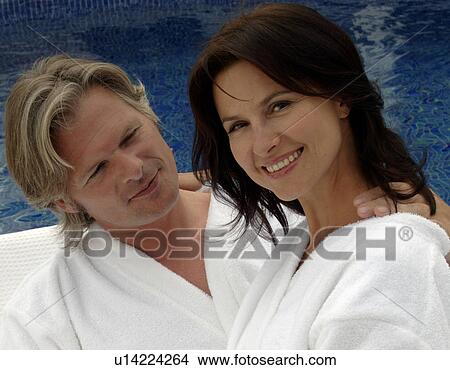 Picture - Couple at the swimming pool in a bathrobe. Fotosearch