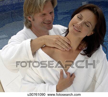 Couple at the swimming pool - man is massaging woman View Large Photo Image Stock Image - Couple at the swimming pool - man is massaging woman. Fotosearch