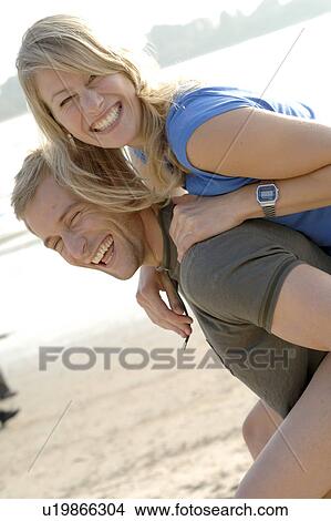 Picture - Couple having fun on the beach. Fotosearch