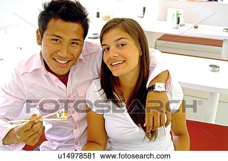 Couple in a sushi restaurant View Large Photo Image Stock Image - Couple in a sushi restaurant. Fotosearch