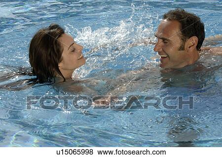 Stock Photo - Couple in swimming pool. Fotosearch