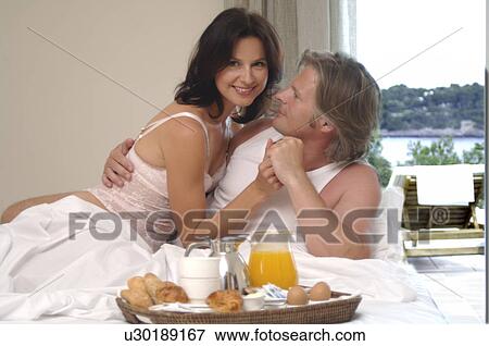 Stock Photo - Couple is having breakfast in bed. Fotosearch