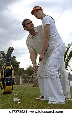 Stock Image - Couple is playing golf. Fotosearch