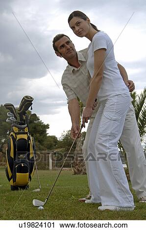 Couple is playing golf View Large Photo Image Stock Image - Couple is playing golf. Fotosearch