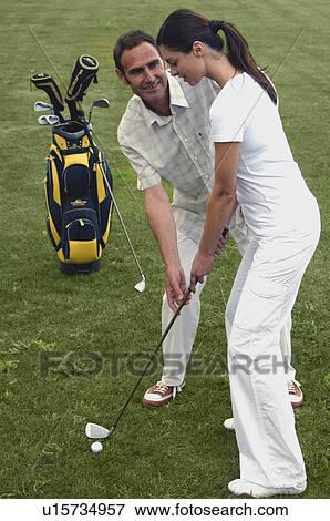 Stock Photo - Couple is playing golf. Fotosearch