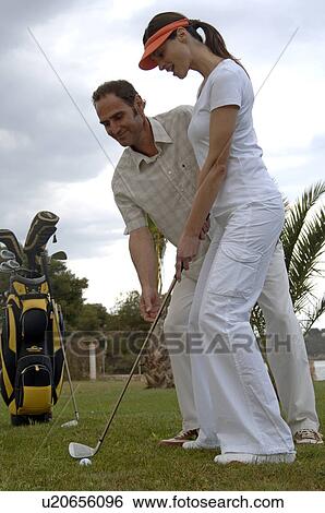 Couple is playing golf View Large Photo Image Stock Photograph - Couple is playing golf. Fotosearch